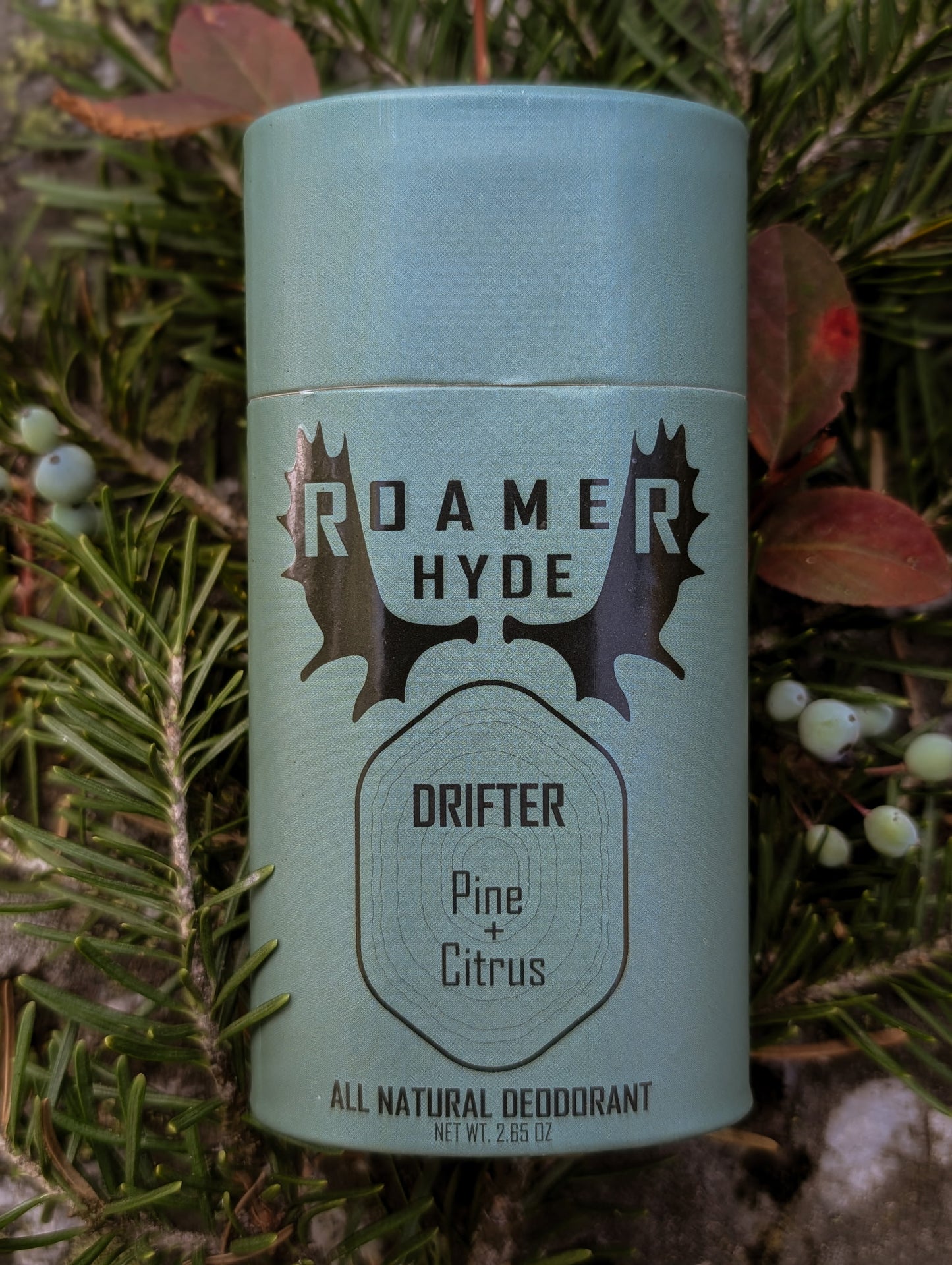 Roamer Hyde deodorant can with natural ingredients on a green leaf background