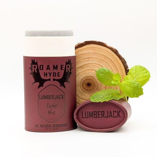 Roamer Hyde Lumberjack deodorant with a wooden log and mint leaves on a white background